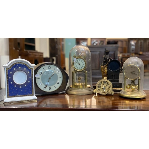 134 - Group of assorted modern and various mantle clocks to include: two perpetual motion clocks under dom... 