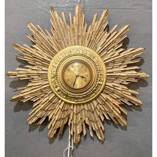 143 - Mid 20th century gilt wood sun-burst clock with electric movement.  Overall 46cm diameter.  (B.P. 21... 