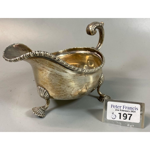 197 - Late Victorian silver helmet shaped sauce boat with gadroon edges, on three shell feet. London 1898.... 