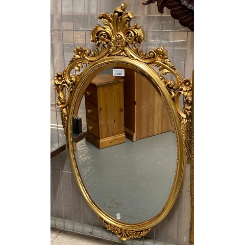 490 - Modern gilt framed bevelled mirror decorated with pierced flowers and foliage.  84cm high approx.   ... 