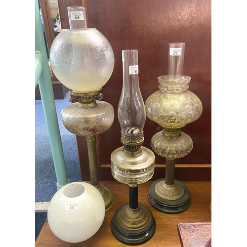 68 - Collection of three early 20th Century double oil burner lamps, together with a spare opaline glass ... 