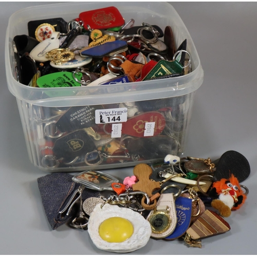 144 - Plastic box of vintage keyrings etc  (B.P. 21% + VAT)