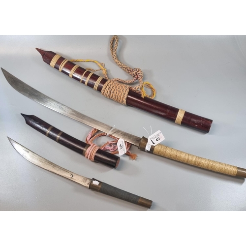 49 - Two Indonesian bladed weapons to include: short sword/dagger and curved sword.  (2)   (B.P. 21% + VA... 