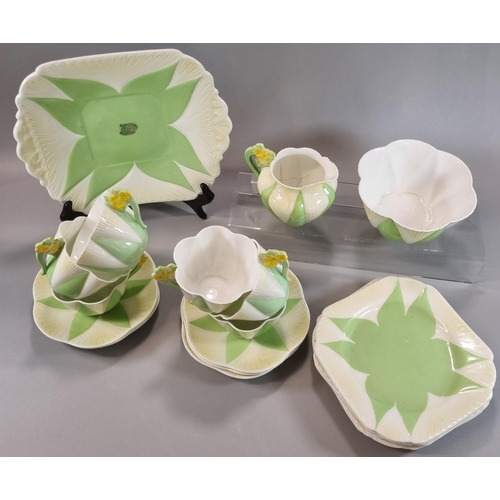 122 - Twenty one piece Shelley bone china Art Deco part tea set on a white and green ground with flowerhea... 