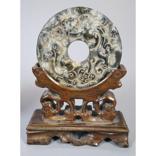 142 - Collection of ten Chinese carved hardstone 'Bi' discs of varying designs including; repeating dragon... 