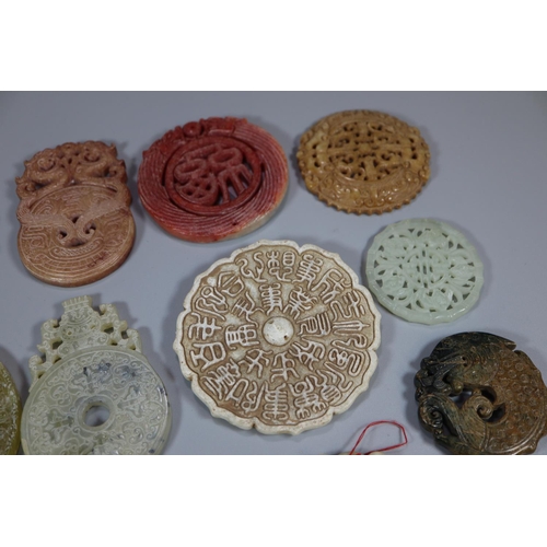 144 - A collection of Chinese carved hardstone 'Bi' discs, varying designs including; character marks and ... 