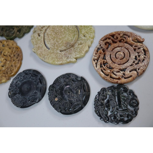 144 - A collection of Chinese carved hardstone 'Bi' discs, varying designs including; character marks and ... 