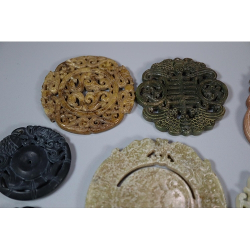 144 - A collection of Chinese carved hardstone 'Bi' discs, varying designs including; character marks and ... 