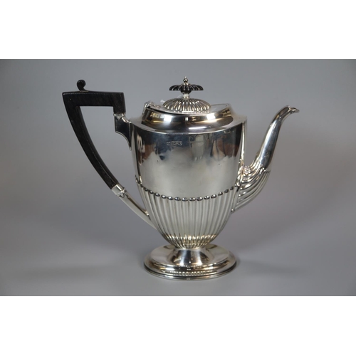 148 - Georgian style silver four piece tea/coffee service with fluted design and ebonised handle and finia... 