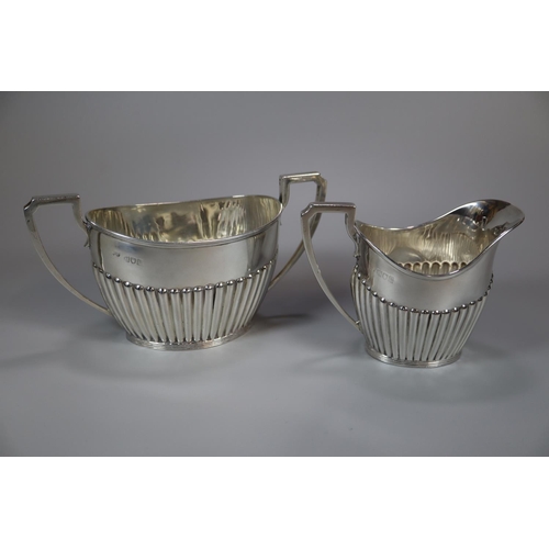 148 - Georgian style silver four piece tea/coffee service with fluted design and ebonised handle and finia... 