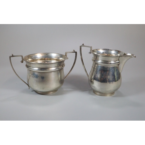 151 - George V silver three piece tea service comprising; two handled sucrier, cream jug and teapot with e... 