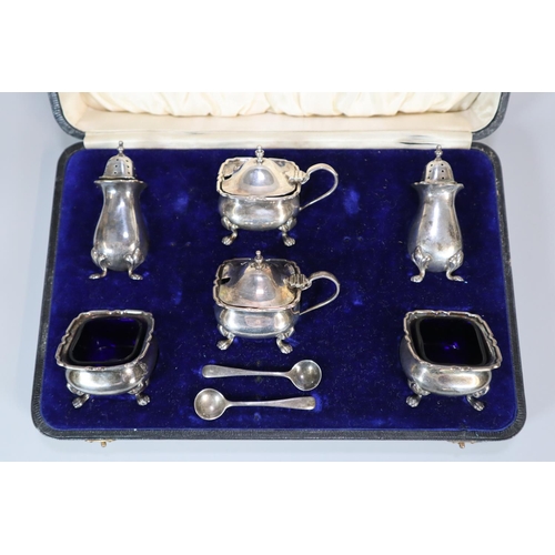 153 - George V silver cased six piece condiment set with blue glass linings. Birmingham hallmarks. 7.45 tr... 