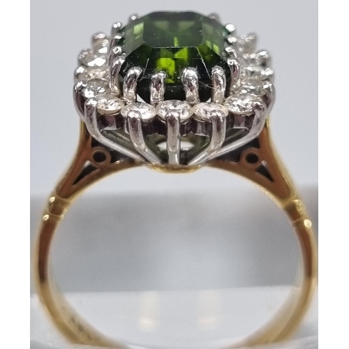 165 - 18ct gold diamond seventeen stone ring inset with central faceted green stone. 4.8g approx. Ring siz... 