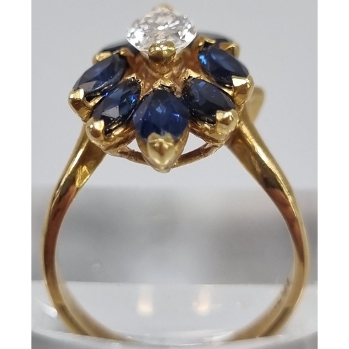 167 - 18ct gold oval cut diamond and eight stone tanzanite flowerhead ring. 5.2g approx. Ring size K.
(B.P... 