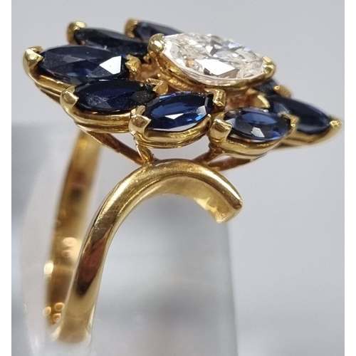 167 - 18ct gold oval cut diamond and eight stone tanzanite flowerhead ring. 5.2g approx. Ring size K.
(B.P... 