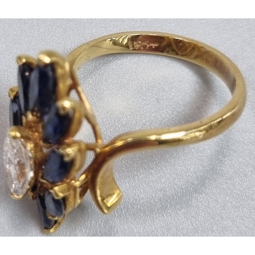 167 - 18ct gold oval cut diamond and eight stone tanzanite flowerhead ring. 5.2g approx. Ring size K.
(B.P... 