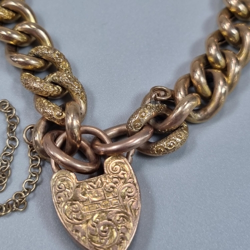 181 - Victorian 9ct gold curb link bracelet with engraved heart shaped locket. 19.6g approx. 
(B.P. 21% + ... 