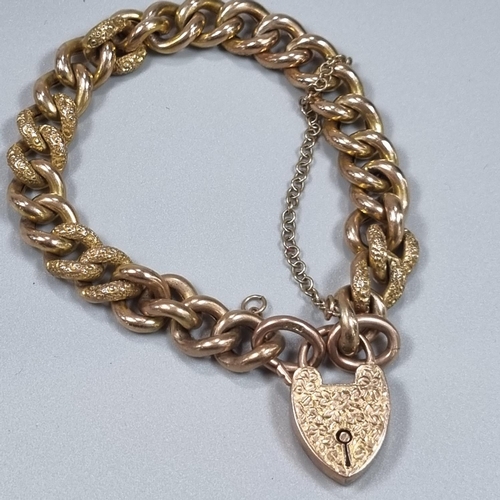 181 - Victorian 9ct gold curb link bracelet with engraved heart shaped locket. 19.6g approx. 
(B.P. 21% + ... 