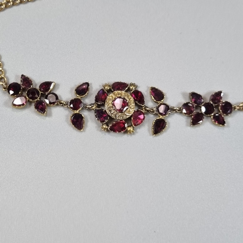 193 - 19th Century 18ct gold curb link necklace pendant set with a cluster of floral stones, probably garn... 