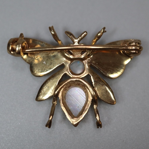 216 - 9ct gold brooch in the form of a butterfly, the wings inset with seed pearls, the body with two opal... 