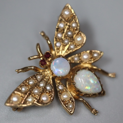 216 - 9ct gold brooch in the form of a butterfly, the wings inset with seed pearls, the body with two opal... 