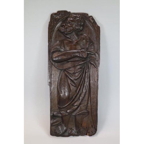 261 - Ecclesiastical carved oak figural panel, probably depicting a Saint in arched niche. 16th century. 4... 