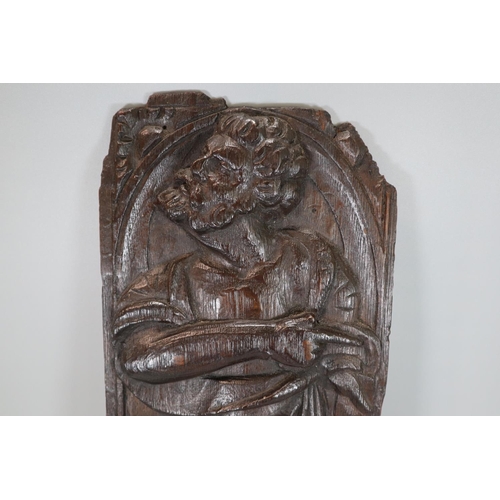 261 - Ecclesiastical carved oak figural panel, probably depicting a Saint in arched niche. 16th century. 4... 