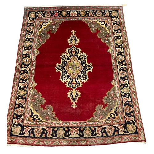 308 - Red ground Persian Tabriz rug with central floral medallion and repeating multi-coloured floral and ... 