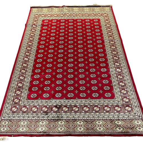 309 - Red ground full pile Kashmir carpet with all over traditional Bokhara designs. 300 x 200cm approx.
(... 