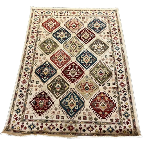 310 - Ivory ground Ziegler full pile rug, overall with diamond medallion, floral and foliate designs. 230 ... 