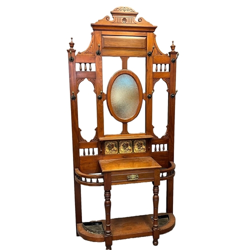 37 - Late Victorian mahogany hallstand, having architectural scrolled pediment above centre oval mirror, ... 