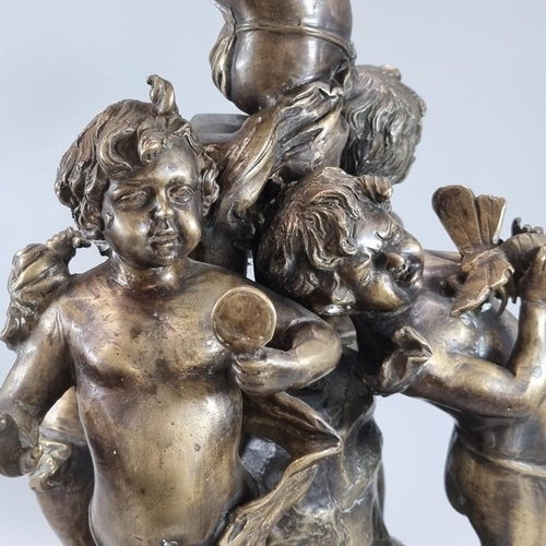 81 - A bronze figure group of dancing cherubs around a central figure on naturalistic circular base and m... 