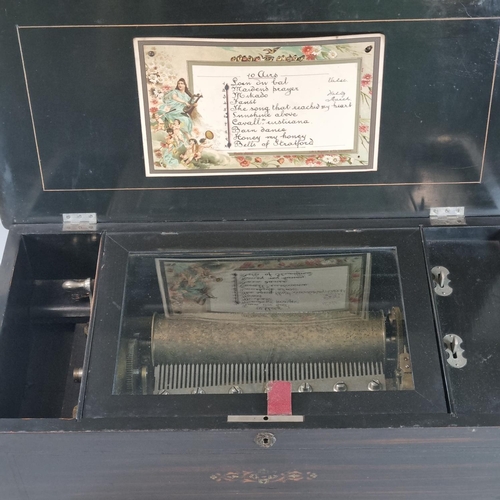 87 - 19th Century Swiss musical box, having inlaid and ebonised case with hinged cover revealing cylinder... 