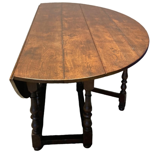9 - Large 17th Century style oval quadruple gate drop leaf dining table, to comfortably seat eight, havi... 
