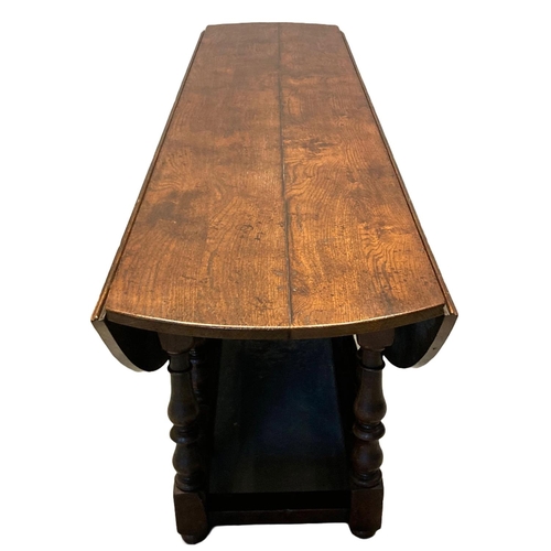 9 - Large 17th Century style oval quadruple gate drop leaf dining table, to comfortably seat eight, havi... 