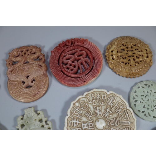 144 - A collection of Chinese carved hardstone 'Bi' discs, varying designs including; character marks and ... 