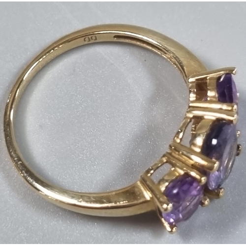 215 - 9ct gold and purple three stone dress ring.  2.7g approx. Size P.   (B.P. 21% + VAT)