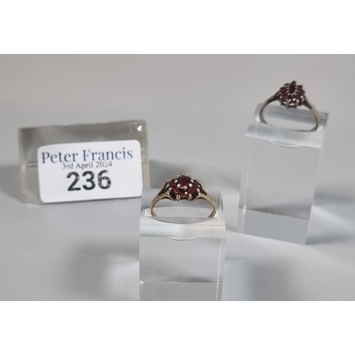 236 - 9ct gold and garnet cluster ring.  1.6g approx.  Size O.  Together with another cluster ring with in... 