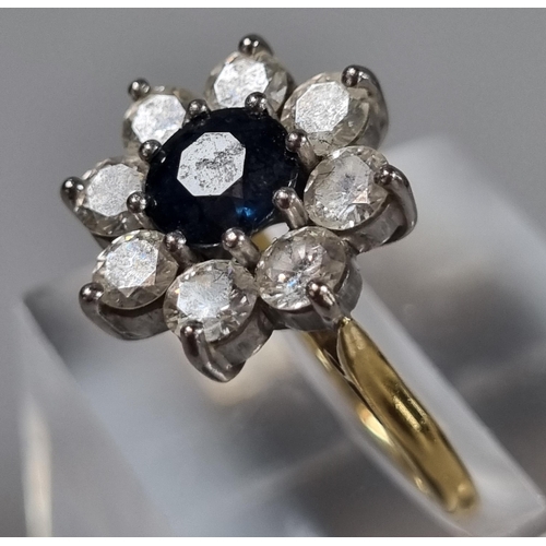 239 - 18ct gold eight stone diamond flower head ring with central sapphire stone.  5.5g approx.  Size K.  ... 