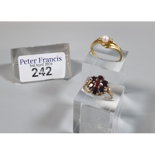 242 - 9ct gold garnet cluster flower head ring. 2.9g approx.  Ring Size M.  Together with a dress ring.  (... 