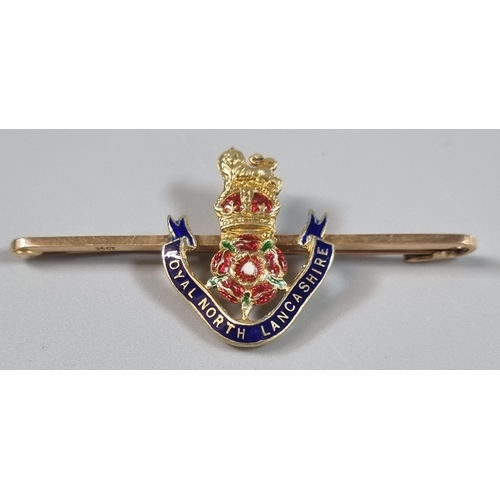 250 - 15ct gold and enamel bar brooch, Loyal North Lancashire.  4.4g approx.   (B.P. 21% + VAT)