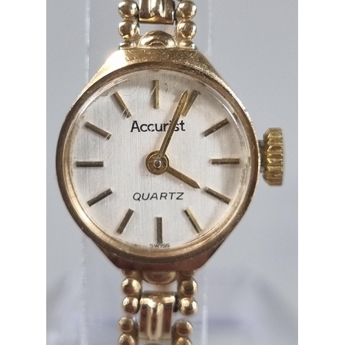 268 - Accurist 9ct gold small head ladies wristwatch with satin face having baton numerals on a 9ct gold b... 