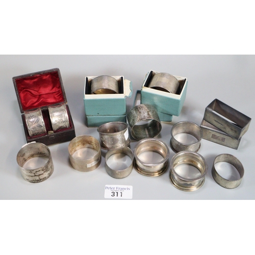 311 - Large collection of silver engine turned and other napkin rings.  12.5 troy oz approx.   (B.P. 21% +... 