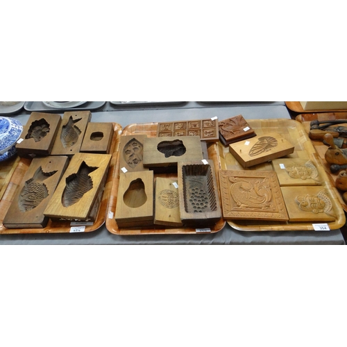 354 - Three trays of carved wooden items; butter and other moulds to include: fish, fan, chrysanthemum, wa... 