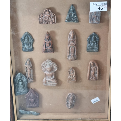 46 - Group of appearing carved devotional figures mounted in a wooden glass fronted display frame togethe... 