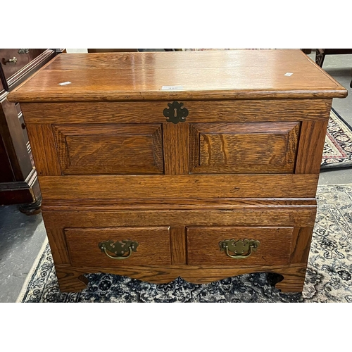 485 - 18th century style oak coffwr bach, the hinged lid and moulded top above two rectangular fielded pan... 