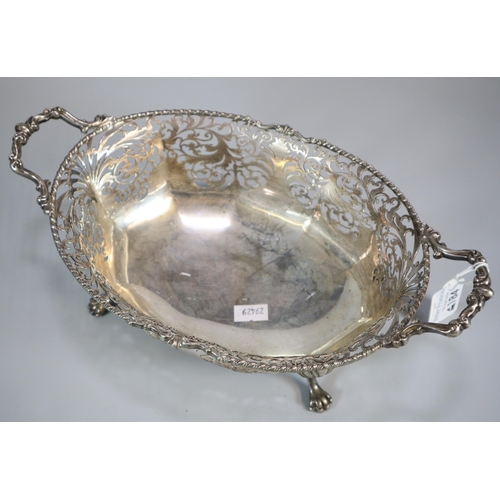 184 - George V silver ornate and pierced two handled centre bowl, raised and standing on four shell and ca... 