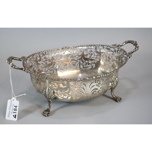 184 - George V silver ornate and pierced two handled centre bowl, raised and standing on four shell and ca... 