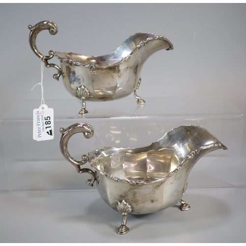 185 - Pair of George V silver sauce boats each standing on three cabriole legs and hoof feet.  By Josiah W... 