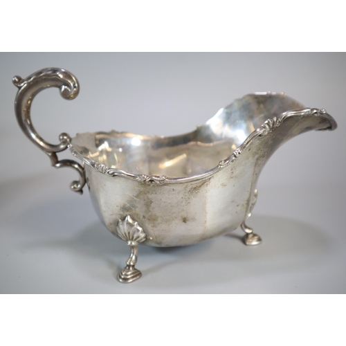 185 - Pair of George V silver sauce boats each standing on three cabriole legs and hoof feet.  By Josiah W... 